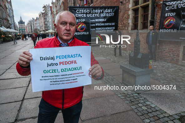 Protester holding sign that says 'Today homosexual - tomorrow pedophile, father, grandpa let's protect our children from sodomites '  during...