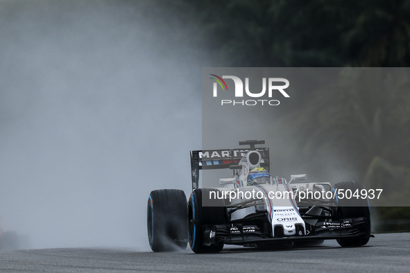 Brazilian Felipe Massa of Williams Martini Racing drives on a wet track during the qualifying session of the Malaysian Formula One Grand Pri...