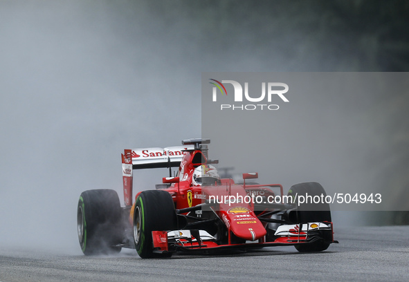 German Sebastian Vettel of Scuderia Ferrari drives on a wet track during the qualifying session of the Malaysian Formula One Grand Prix at S...
