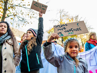 Some little girls are seen holding placards supporting their teacher mother during the massive teachers demonstration that took place in The...