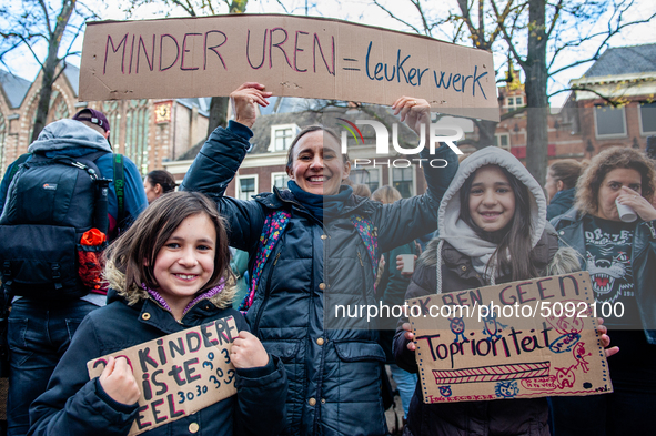 A woman and her daughters are seen holding placards, during the massive teachers demonstration that took place in The Hague, on November 6th...