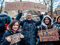 A woman and her daughters are seen holding placards, during the massive teachers demonstration that took place in The Hague, on November 6th...