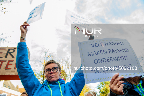 A woman is seen holding placards during the massive teachers demonstration that took place in The Hague, on November 6th, 2019. 