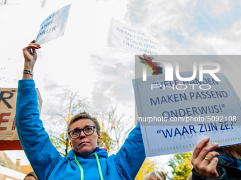 A woman is seen holding placards during the massive teachers demonstration that took place in The Hague, on November 6th, 2019. (