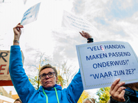 A woman is seen holding placards during the massive teachers demonstration that took place in The Hague, on November 6th, 2019. (