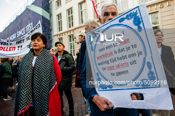 A man is seen holding a placard during the massive teachers demonstration that took place in The Hague, on November 6th, 2019. 