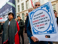 A man is seen holding a placard during the massive teachers demonstration that took place in The Hague, on November 6th, 2019. (