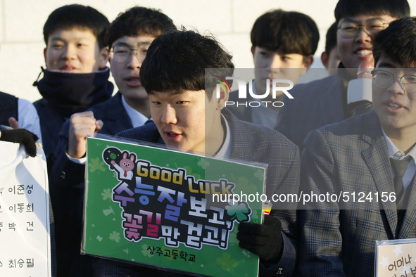 Nov 14, 2019 - Sangju, South Korea-A Group of High Schoolers cheer up for their senior group at entrance gate of Sangju high school in Sangj...