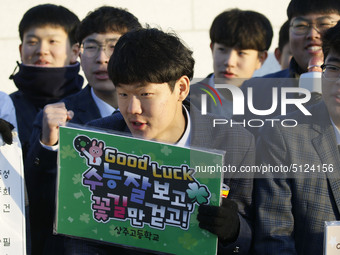 Nov 14, 2019 - Sangju, South Korea-A Group of High Schoolers cheer up for their senior group at entrance gate of Sangju high school in Sangj...