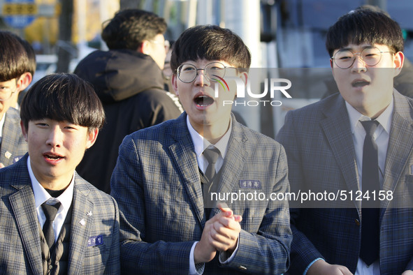 Nov 14, 2019 - Sangju, South Korea-A Group of High Schoolers cheer up for their senior group at entrance gate of Sangju high school in Sangj...