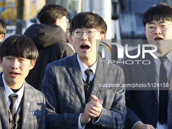 Nov 14, 2019 - Sangju, South Korea-A Group of High Schoolers cheer up for their senior group at entrance gate of Sangju high school in Sangj...