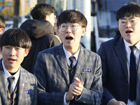 Nov 14, 2019 - Sangju, South Korea-A Group of High Schoolers cheer up for their senior group at entrance gate of Sangju high school in Sangj...