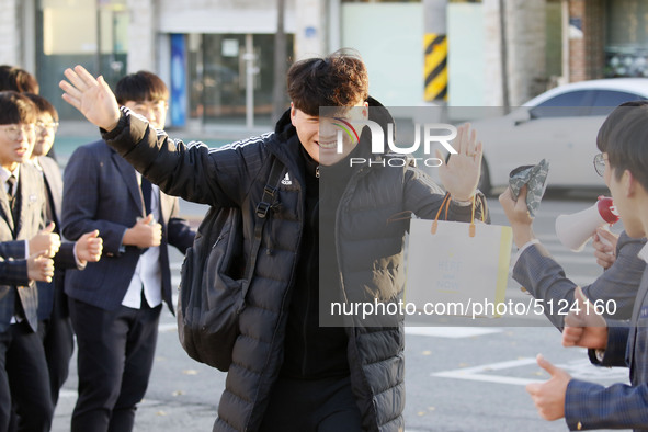 Nov 14, 2019 - Sangju, South Korea-A Group of High Schoolers cheer up for their senior group at entrance gate of Sangju high school in Sangj...