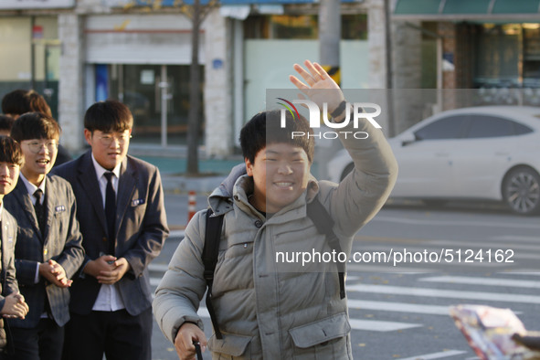 Nov 14, 2019 - Sangju, South Korea-A Group of High Schoolers cheer up for their senior group at entrance gate of Sangju high school in Sangj...