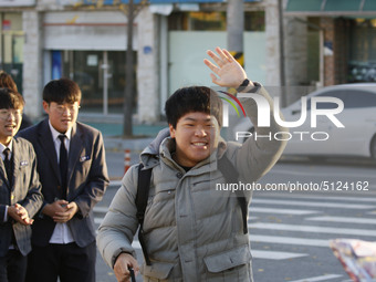 Nov 14, 2019 - Sangju, South Korea-A Group of High Schoolers cheer up for their senior group at entrance gate of Sangju high school in Sangj...