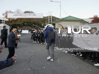 Nov 14, 2019 - Sangju, South Korea-A Group of High Schoolers cheer up for their senior group at entrance gate of Sangju high school in Sangj...