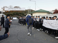 Nov 14, 2019 - Sangju, South Korea-A Group of High Schoolers cheer up for their senior group at entrance gate of Sangju high school in Sangj...