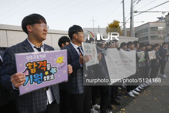 Nov 14, 2019 - Sangju, South Korea-A Group of High Schoolers cheer up for their senior group at entrance gate of Sangju high school in Sangj...