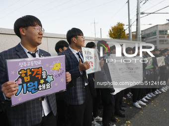 Nov 14, 2019 - Sangju, South Korea-A Group of High Schoolers cheer up for their senior group at entrance gate of Sangju high school in Sangj...