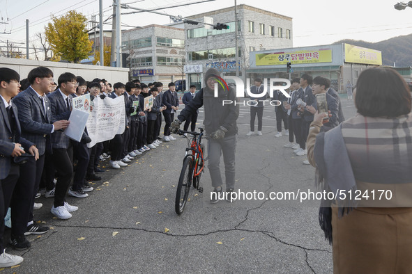 Nov 14, 2019 - Sangju, South Korea-A Group of High Schoolers cheer up for their senior group at entrance gate of Sangju high school in Sangj...