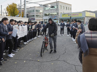 Nov 14, 2019 - Sangju, South Korea-A Group of High Schoolers cheer up for their senior group at entrance gate of Sangju high school in Sangj...