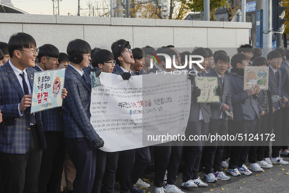 Nov 14, 2019 - Sangju, South Korea-A Group of High Schoolers cheer up for their senior group at entrance gate of Sangju high school in Sangj...