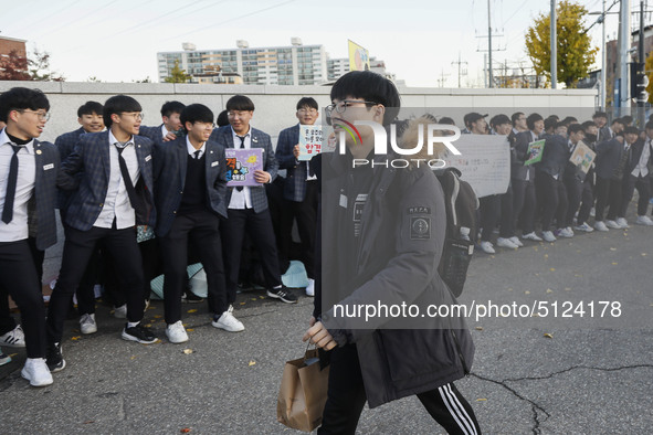 Nov 14, 2019 - Sangju, South Korea-A Group of High Schoolers cheer up for their senior group at entrance gate of Sangju high school in Sangj...