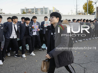 Nov 14, 2019 - Sangju, South Korea-A Group of High Schoolers cheer up for their senior group at entrance gate of Sangju high school in Sangj...