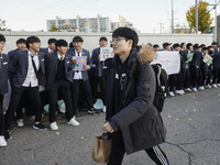 Nov 14, 2019 - Sangju, South Korea-A Group of High Schoolers cheer up for their senior group at entrance gate of Sangju high school in Sangj...