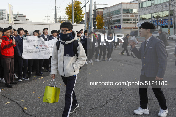 Nov 14, 2019 - Sangju, South Korea-A Group of High Schoolers cheer up for their senior group at entrance gate of Sangju high school in Sangj...