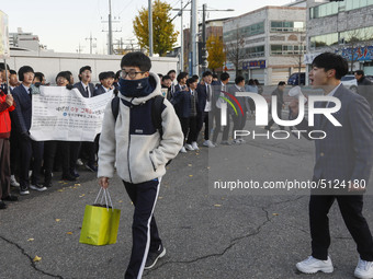 Nov 14, 2019 - Sangju, South Korea-A Group of High Schoolers cheer up for their senior group at entrance gate of Sangju high school in Sangj...