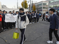 Nov 14, 2019 - Sangju, South Korea-A Group of High Schoolers cheer up for their senior group at entrance gate of Sangju high school in Sangj...