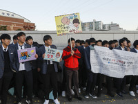 Nov 14, 2019 - Sangju, South Korea-A Group of High Schoolers cheer up for their senior group at entrance gate of Sangju high school in Sangj...