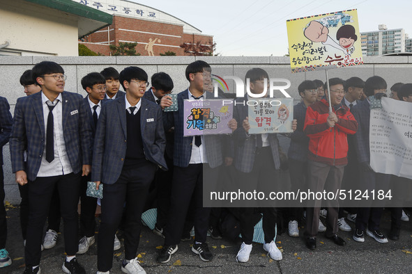 Nov 14, 2019 - Sangju, South Korea-A Group of High Schoolers cheer up for their senior group at entrance gate of Sangju high school in Sangj...