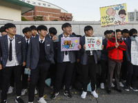 Nov 14, 2019 - Sangju, South Korea-A Group of High Schoolers cheer up for their senior group at entrance gate of Sangju high school in Sangj...