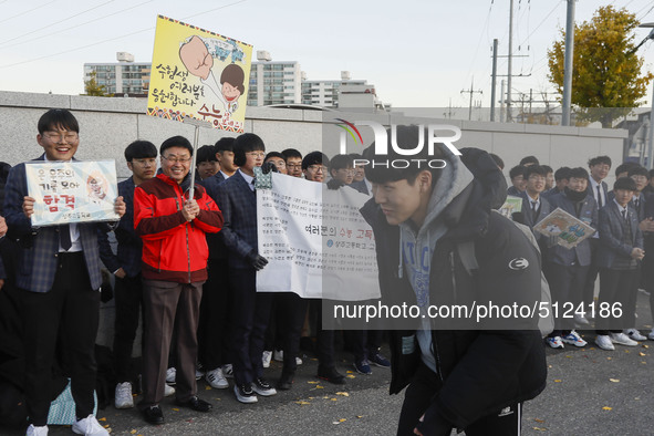 Nov 14, 2019 - Sangju, South Korea-A Group of High Schoolers cheer up for their senior group at entrance gate of Sangju high school in Sangj...