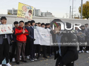 Nov 14, 2019 - Sangju, South Korea-A Group of High Schoolers cheer up for their senior group at entrance gate of Sangju high school in Sangj...