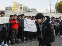 Nov 14, 2019 - Sangju, South Korea-A Group of High Schoolers cheer up for their senior group at entrance gate of Sangju high school in Sangj...