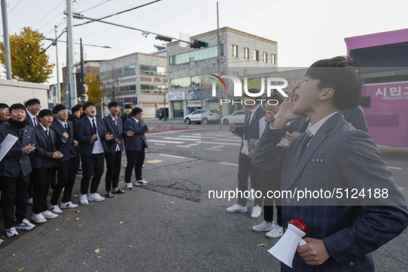 Nov 14, 2019 - Sangju, South Korea-A Group of High Schoolers cheer up for their senior group at entrance gate of Sangju high school in Sangj...