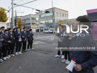 Nov 14, 2019 - Sangju, South Korea-A Group of High Schoolers cheer up for their senior group at entrance gate of Sangju high school in Sangj...