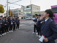 Nov 14, 2019 - Sangju, South Korea-A Group of High Schoolers cheer up for their senior group at entrance gate of Sangju high school in Sangj...