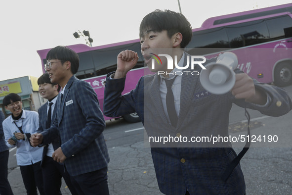 Nov 14, 2019 - Sangju, South Korea-A Group of High Schoolers cheer up for their senior group at entrance gate of Sangju high school in Sangj...