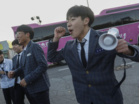 Nov 14, 2019 - Sangju, South Korea-A Group of High Schoolers cheer up for their senior group at entrance gate of Sangju high school in Sangj...