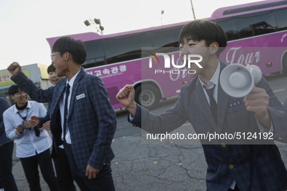 Nov 14, 2019 - Sangju, South Korea-A Group of High Schoolers cheer up for their senior group at entrance gate of Sangju high school in Sangj...