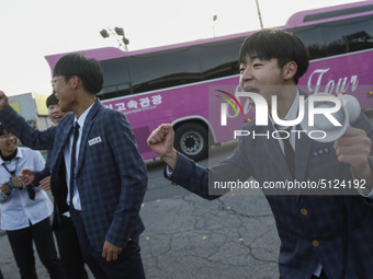 Nov 14, 2019 - Sangju, South Korea-A Group of High Schoolers cheer up for their senior group at entrance gate of Sangju high school in Sangj...