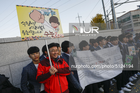 Nov 14, 2019 - Sangju, South Korea-A Group of High Schoolers cheer up for their senior group at entrance gate of Sangju high school in Sangj...