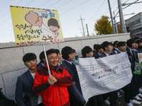 Nov 14, 2019 - Sangju, South Korea-A Group of High Schoolers cheer up for their senior group at entrance gate of Sangju high school in Sangj...