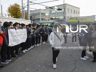 Nov 14, 2019 - Sangju, South Korea-A Group of High Schoolers cheer up for their senior group at entrance gate of Sangju high school in Sangj...