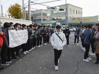 Nov 14, 2019 - Sangju, South Korea-A Group of High Schoolers cheer up for their senior group at entrance gate of Sangju high school in Sangj...