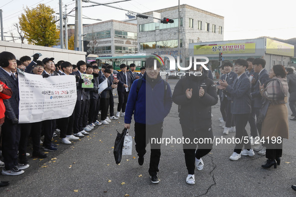 Nov 14, 2019 - Sangju, South Korea-A Group of High Schoolers cheer up for their senior group at entrance gate of Sangju high school in Sangj...